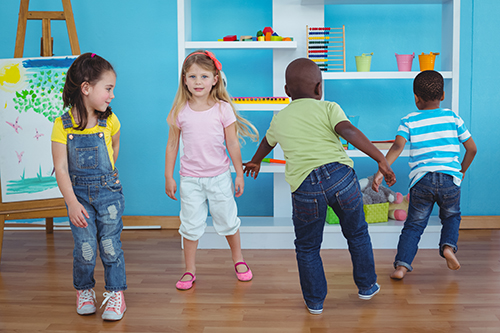 Happy kids playing games together in the bedroom